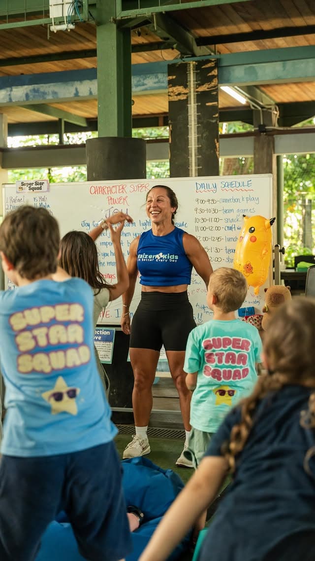 Coach Liz leading a game with children at a Kaizen Kids holiday camp